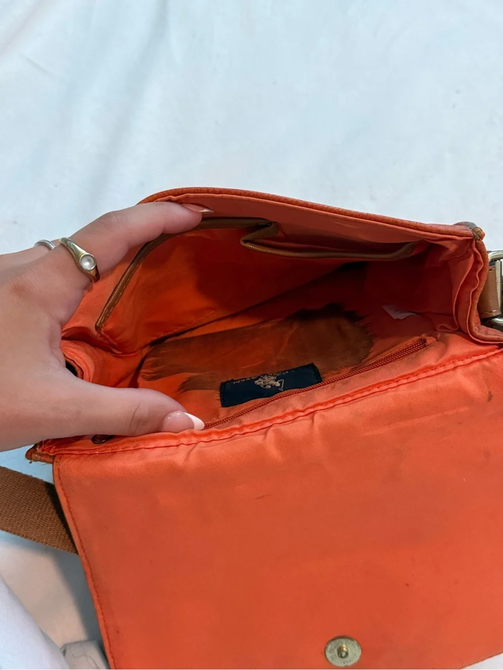 Orange U.S. Polo Assn. leather crossbody bag with brown strap